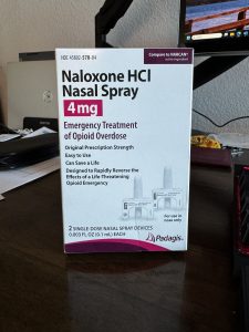 Photo of Naloxone spray box sitting on my desk.
